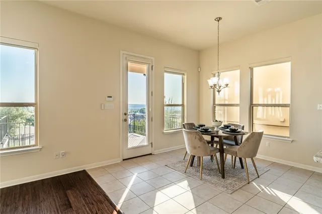 a living room with furniture and floor to ceiling windows