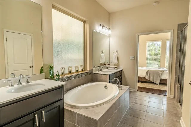 a bathroom with a sink double vanity and a mirror