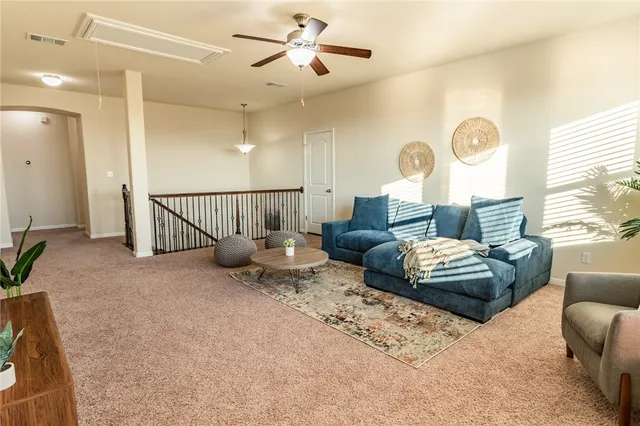 a living room with furniture chess floor and a large window