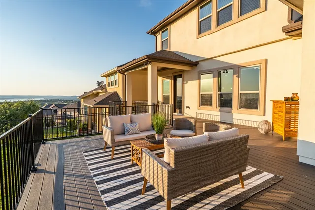 a view of a patio with couches chairs and wooden floor