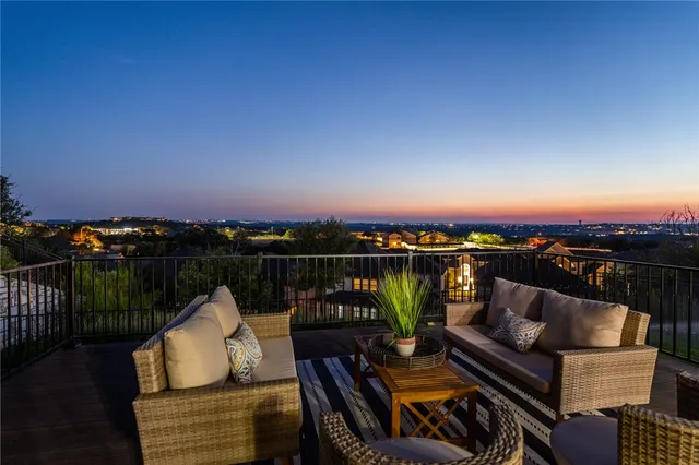 a view of a balcony with chairs