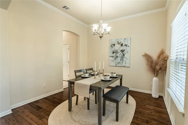 a view of a dining room with furniture and chandelier