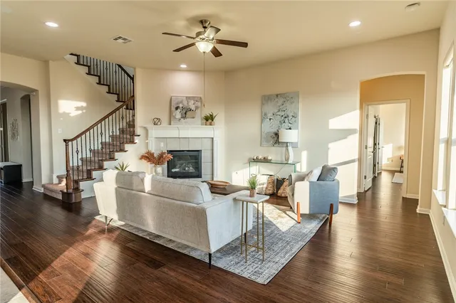 a living room with fireplace furniture and a wooden floor