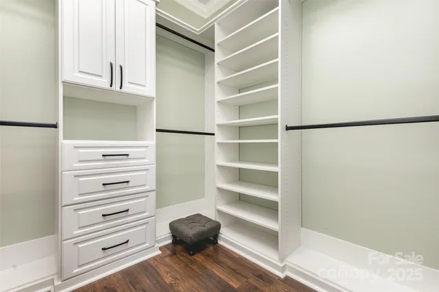 a view of walk in closet with empty racks