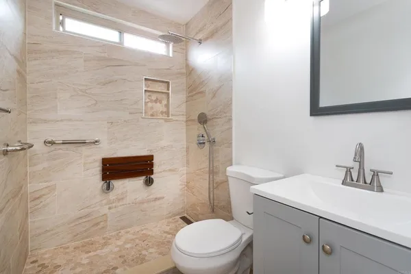 a bathroom with a sink a toilet and shower