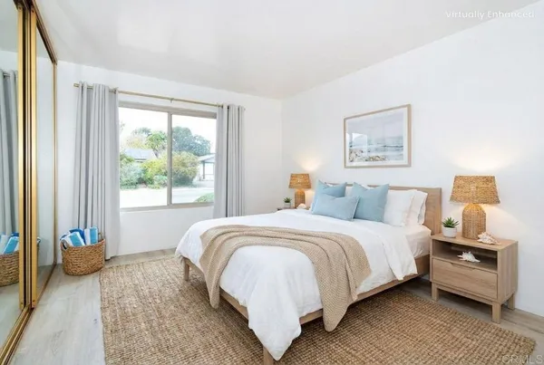 a bedroom with a bed and a large window