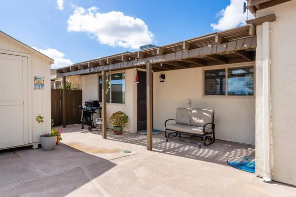 a view of backyard with wheel chair and potted plants