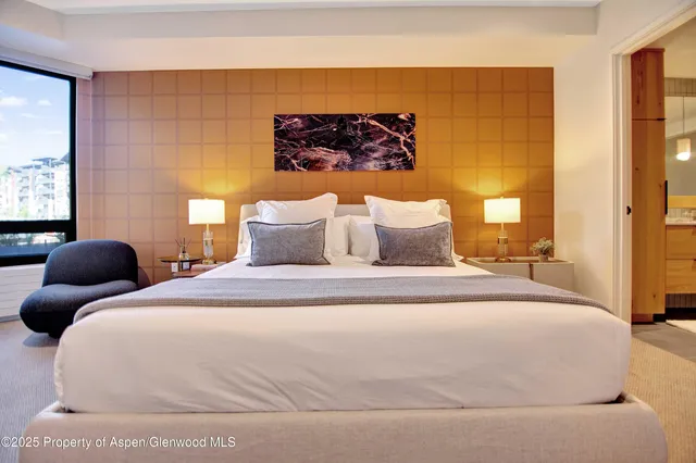 a large white bed in a small room