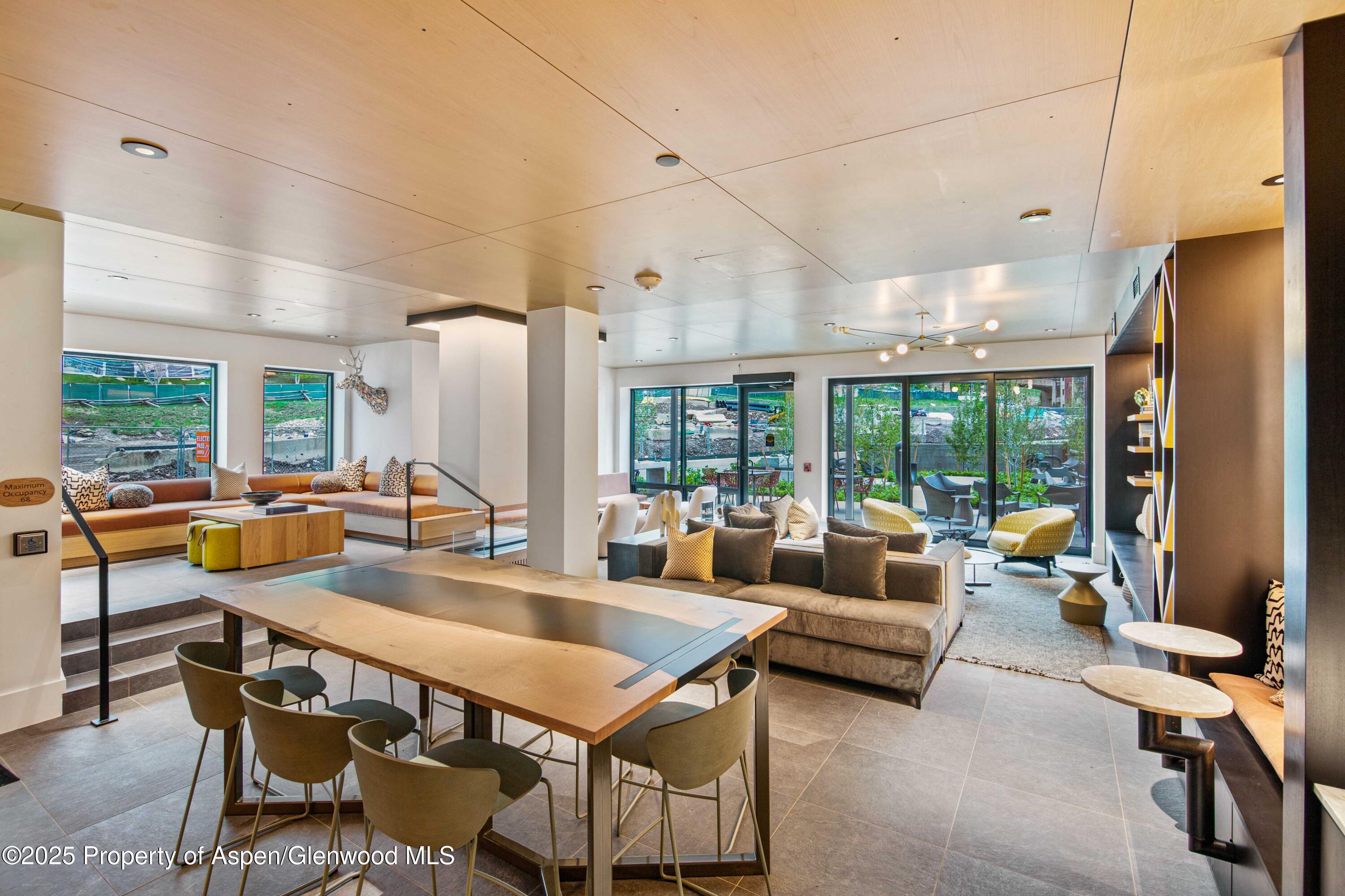 119 Wood Road, Unit 207 Snowmass Village, CO 81615 - Photo 16 of 26 a outdoor space with furniture and large windows