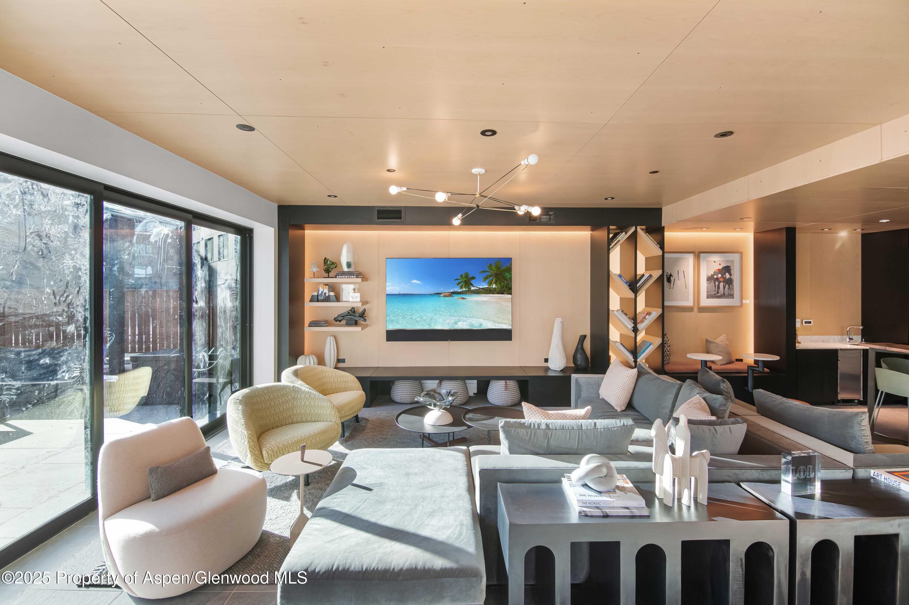 119 Wood Road, Unit 207 Snowmass Village, CO 81615 - Photo 18 of 26 a living room with furniture and floor to ceiling window