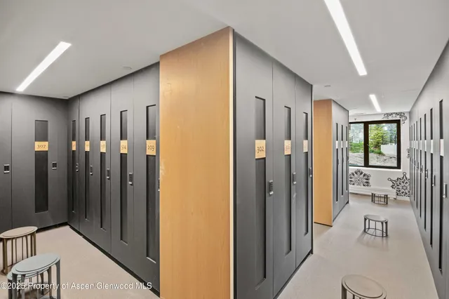 a view of a hallway with bathroom and glass door