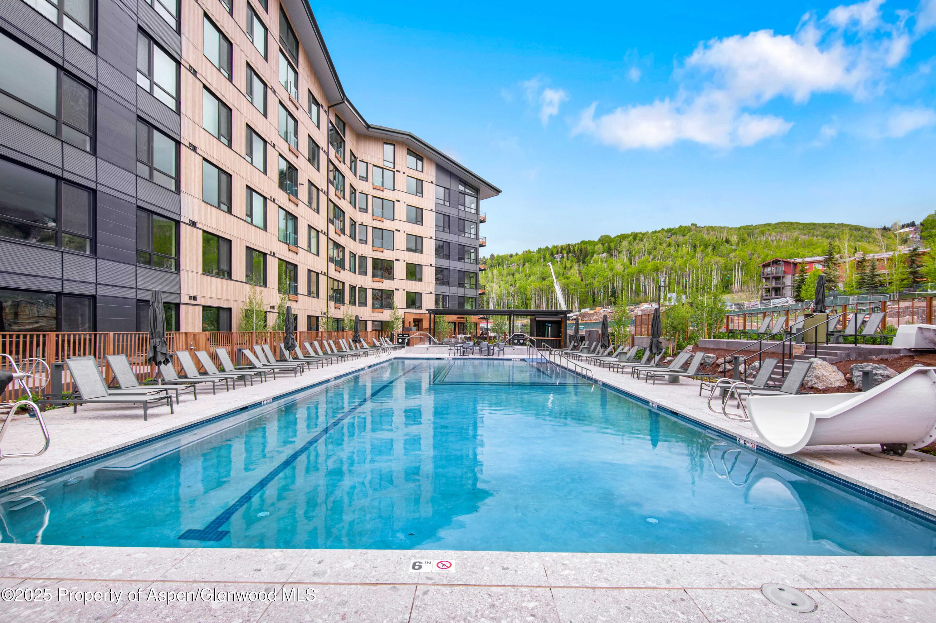 119 Wood Road, Unit 207 Snowmass Village, CO 81615 - Photo 22 of 26 a view of a swimming pool with a lounge chair