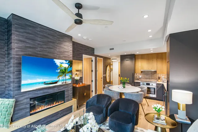 a living room with fireplace furniture and a flat screen tv