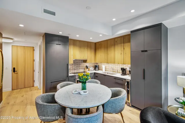 a kitchen with a table and chairs