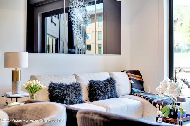 a living room with furniture and a potted plant