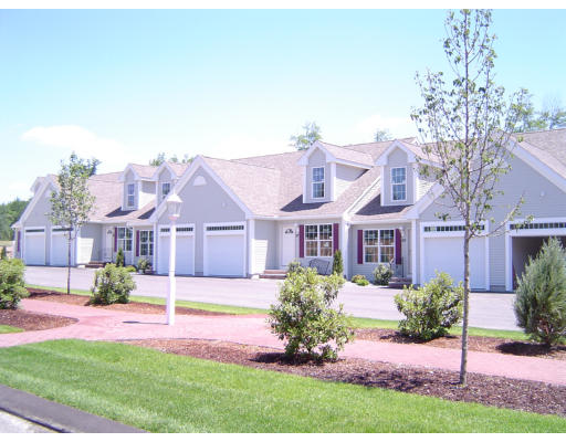 32 Brookview Road, Unit 6 1 Windham, NH 03087 - Photo 1 of 1 a front view of a house with a yard and potted plants