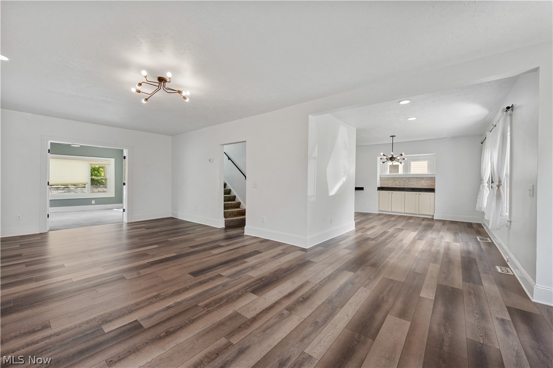 371 Merriman Road Akron, OH 44303 - Photo 6 of 27 Spacious room featuring wood-finish flooring, white walls, and a contemporary ceiling light fixture