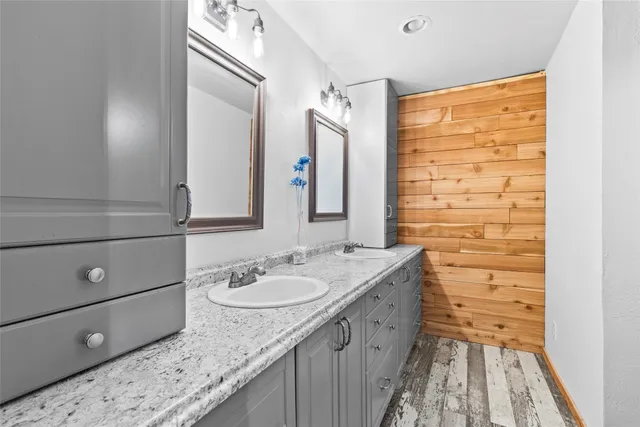 a bathroom with a granite countertop sink and a mirror