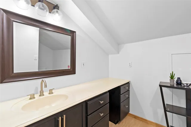 a bathroom with a sink vanity and a mirror