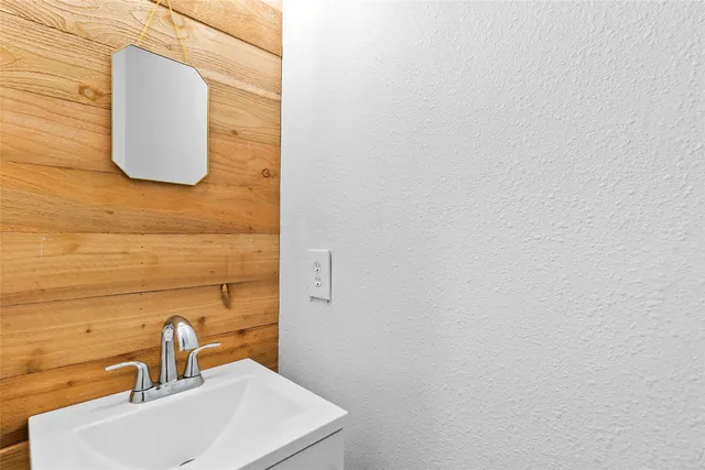 a bathroom with a sink and mirror