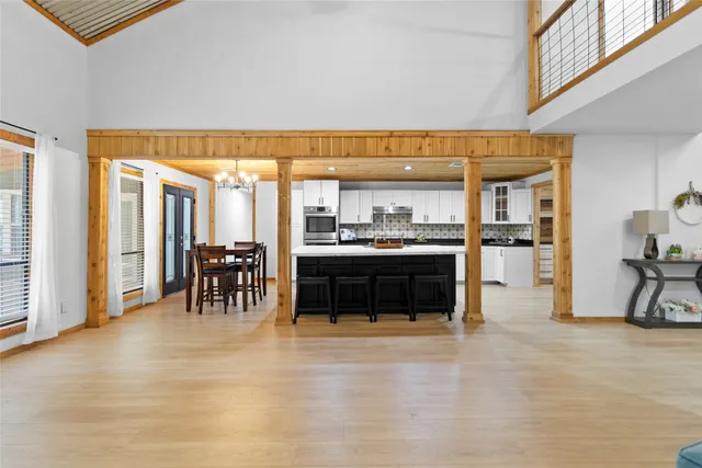 a living room with furniture a flat screen tv and a table