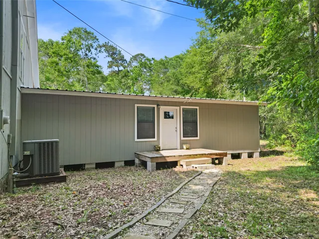 a backyard of a house with yard and outdoor seating