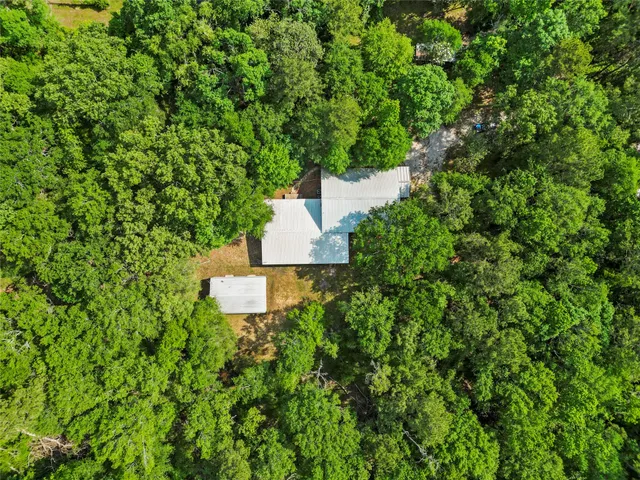 a backyard of a house with lots of green space and a fountain