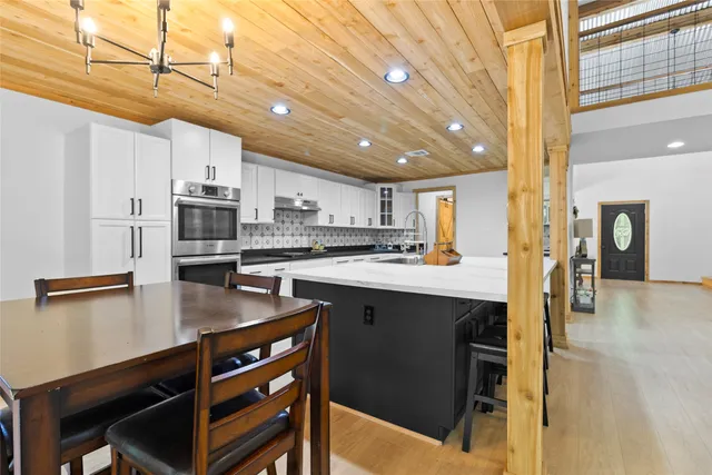 a kitchen with stainless steel appliances granite countertop a sink a stove and refrigerator