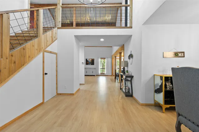 a view of a hallway with wooden floor and staircase