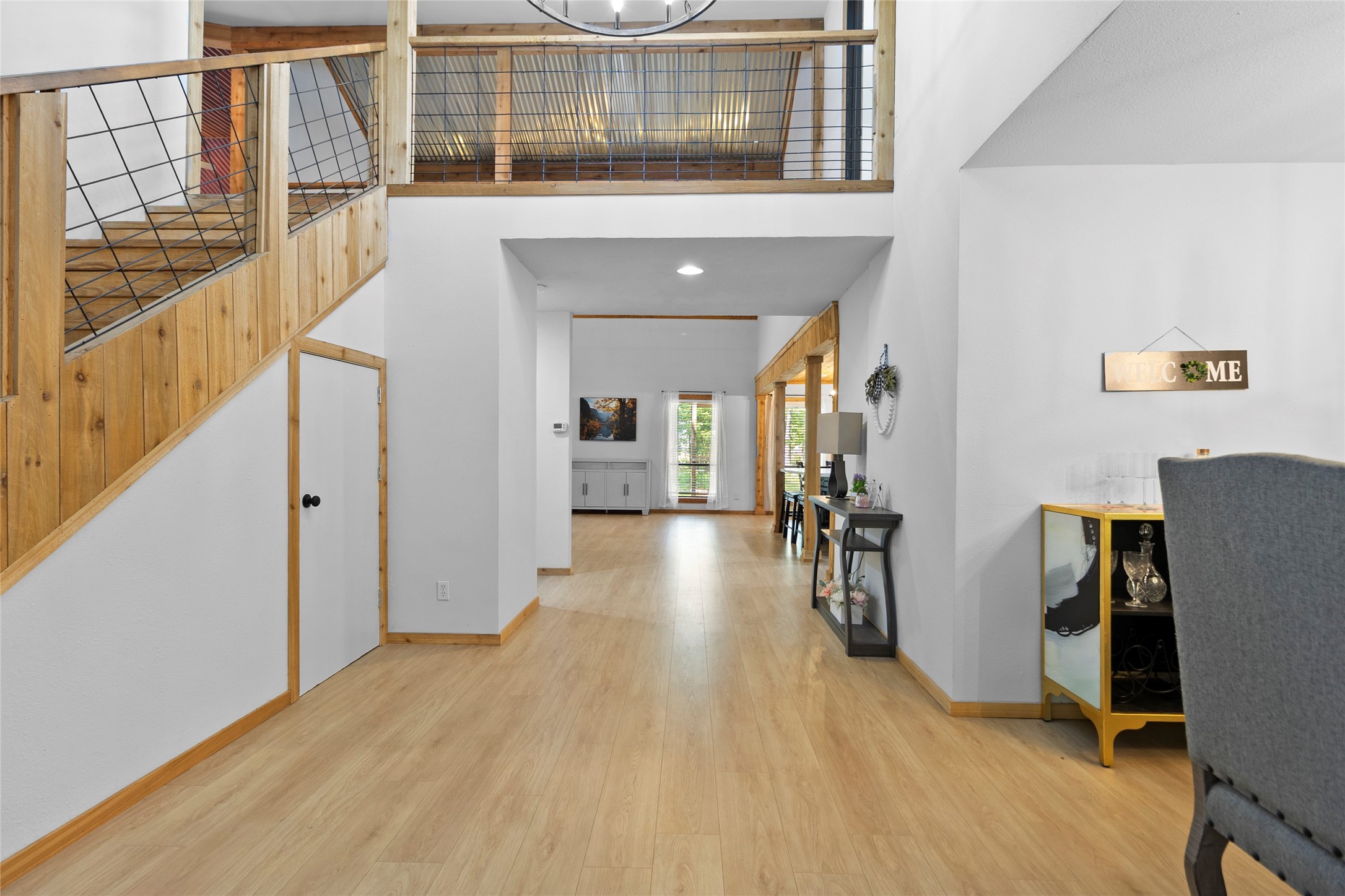 553 County Road 370 Splendora, TX 77372 - Photo 9 of 41 a view of a hallway with wooden floor and staircase