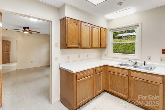 a kitchen with stainless steel appliances granite countertop a refrigerator sink and white cabinets
