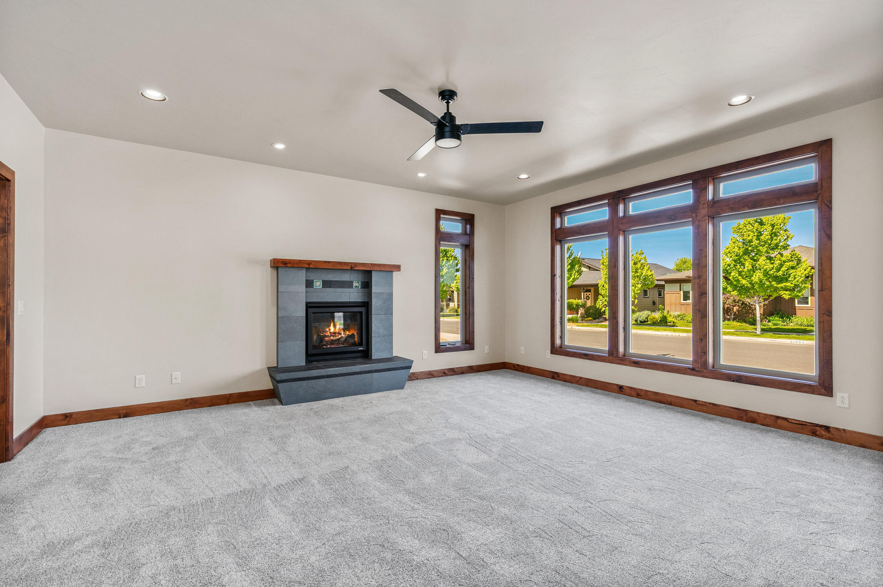 1472 Northeast Hudspeth Road Prineville, OR 97754 - Photo 6 of 26 a view of an empty room with a fireplace and a window