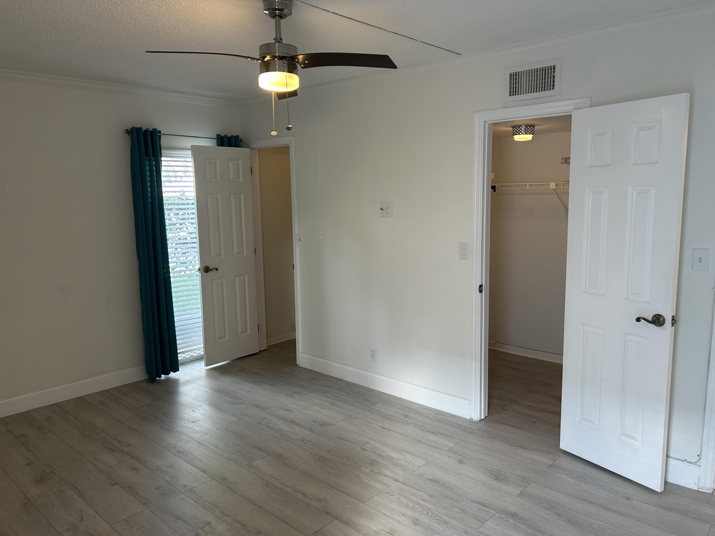 6514 Spring Bottom Way, Unit 125 Boca Raton, FL 33433 - Photo 13 of 28 an empty room with wooden floor and entrance