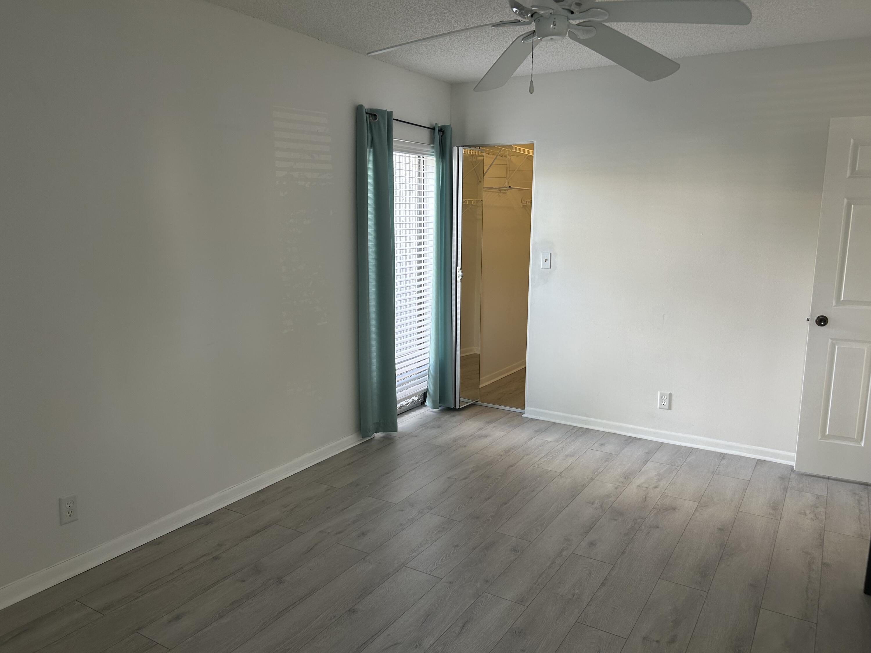6514 Spring Bottom Way, Unit 125 Boca Raton, FL 33433 - Photo 17 of 28 an empty room with a window and a fan