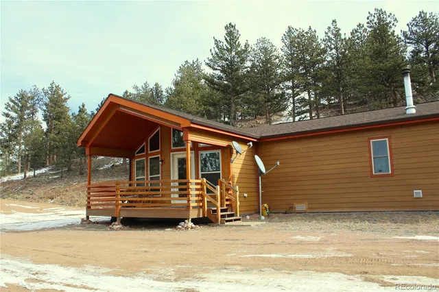 a backyard of a house with barbeque oven and trees