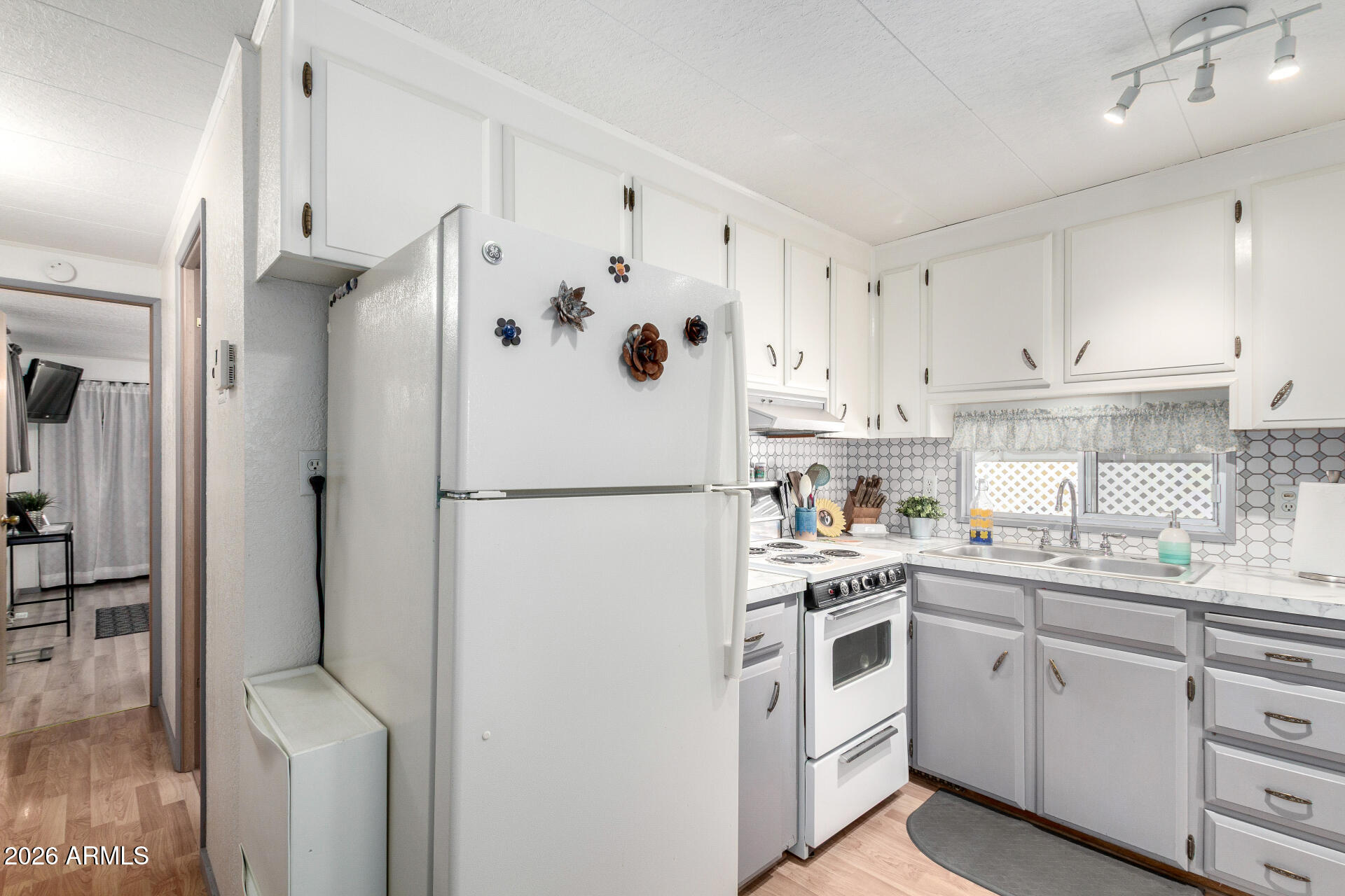 800 West Apache Trail, Unit 93 Apache Junction, AZ 85120 - Photo 22 of 28 a white refrigerator freezer sitting inside of a kitchen