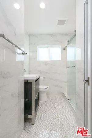 a bathroom with a toilet sink and shower