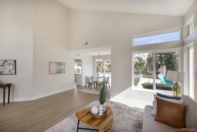 a living room with furniture and a floor to ceiling window