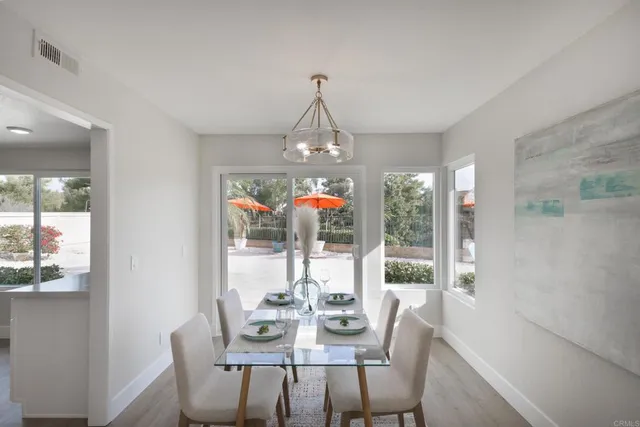 a view of a dining room with furniture wooden floor and chandelier