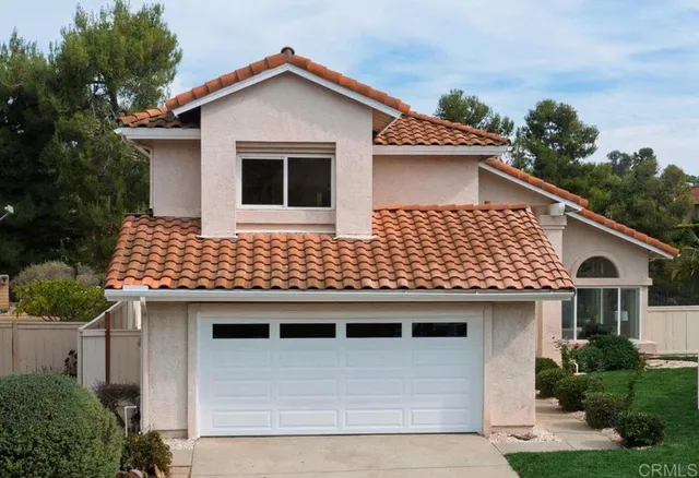 a front view of a house with a garage