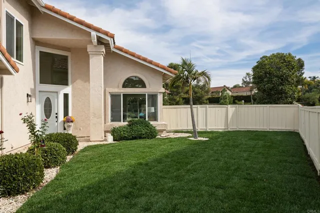 a view of an house with backyard space and garden