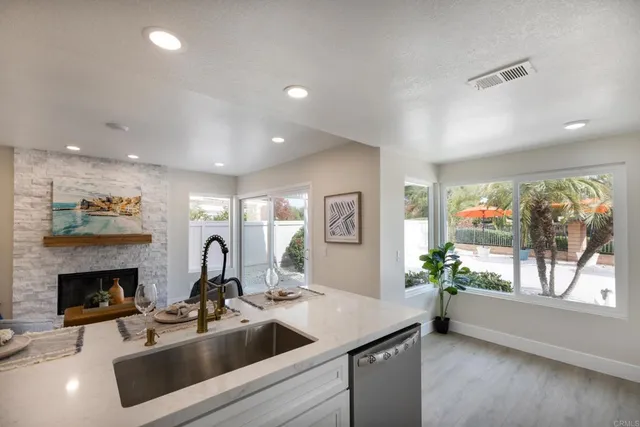 a kitchen with a sink and a fireplace