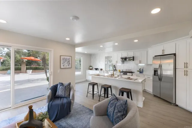 a large kitchen with a table and chairs