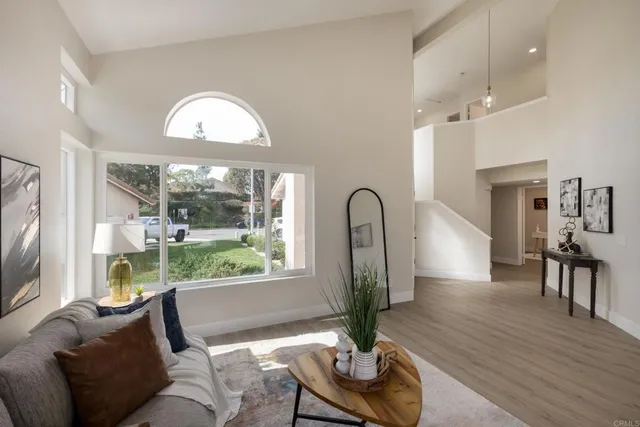 a living room with furniture flowerpot and wooden floor