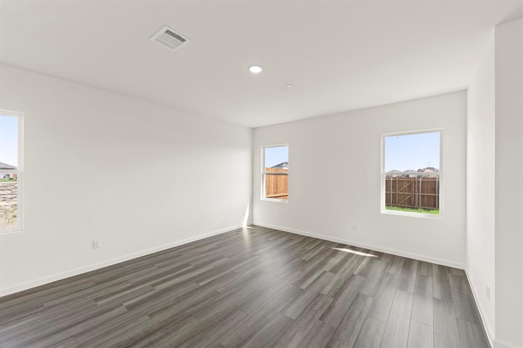 1508 Lake Alpine Trail Anna, TX 75409 - Photo 21 of 40 a view of an empty room with wooden floor and a window