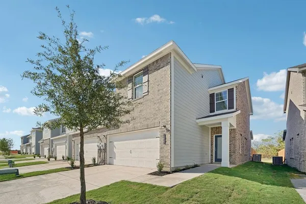 a large kitchen with stainless steel appliances granite countertop a stove a sink a refrigerator and white cabinets granite countertops with wooden floor