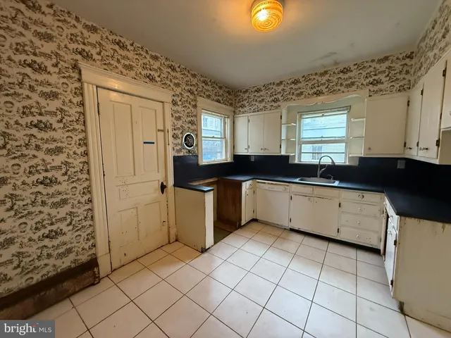 a kitchen with a sink a stove and cabinets
