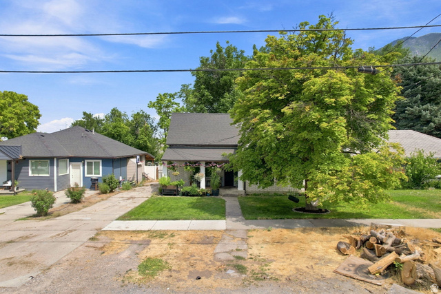 154 West 400 North Springville, UT 84663 - Photo 6 of 43 Exterior featuring a mature tree, manicured lawn, and paved walkway leading to the entrance