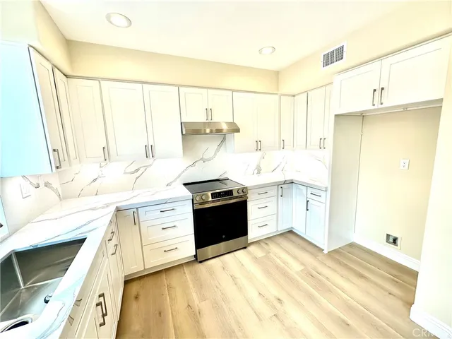 a kitchen with a sink stove and refrigerator