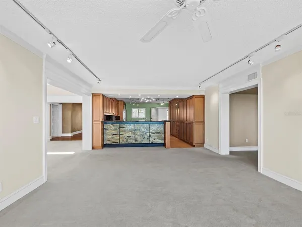 a kitchen with granite countertop a sink and cabinets